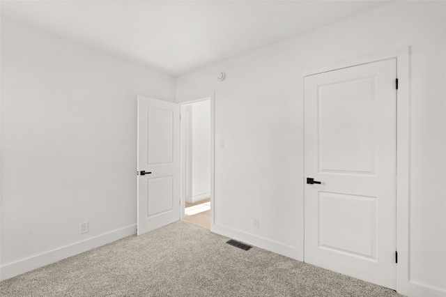 unfurnished room with light colored carpet