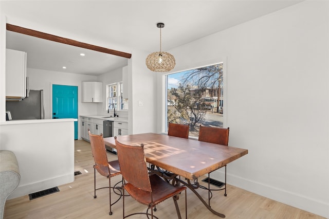 dining space featuring light hardwood / wood-style floors and sink