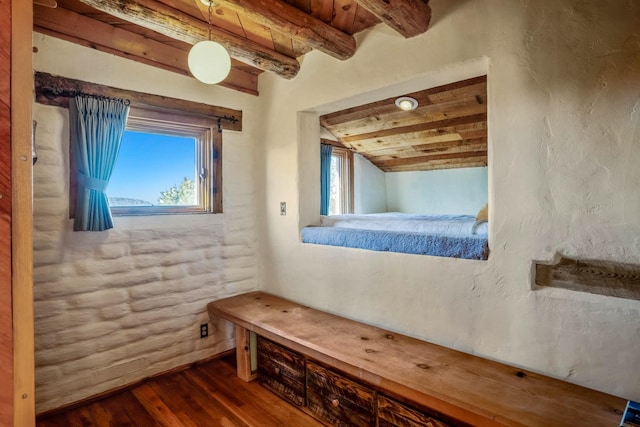 interior space with lofted ceiling with beams, hardwood / wood-style flooring, plenty of natural light, and wood ceiling