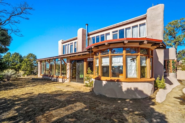 rear view of house with a sunroom