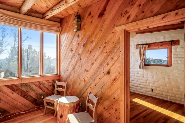 unfurnished room with hardwood / wood-style flooring, a healthy amount of sunlight, wood ceiling, and beam ceiling