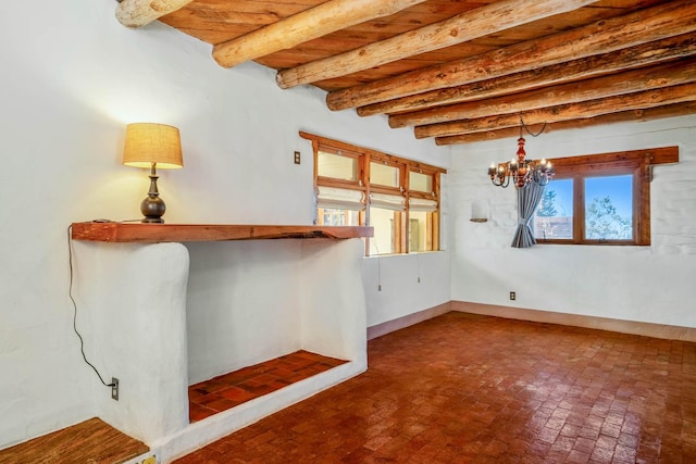 unfurnished room with beamed ceiling and a chandelier