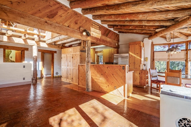 unfurnished living room featuring wood-type flooring, beam ceiling, a notable chandelier, and wood ceiling