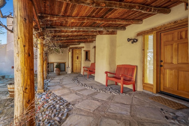 interior space with beam ceiling and a wealth of natural light