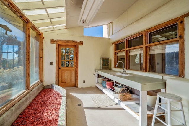 interior space with sink and vaulted ceiling