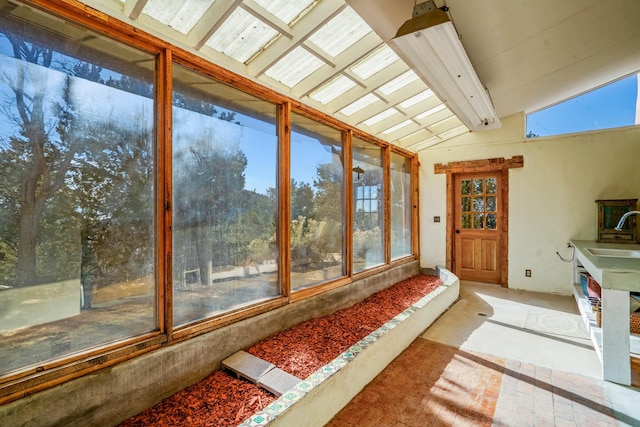 sunroom / solarium with vaulted ceiling with beams and sink