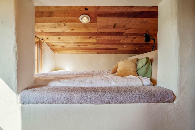 bedroom with beamed ceiling and wooden ceiling