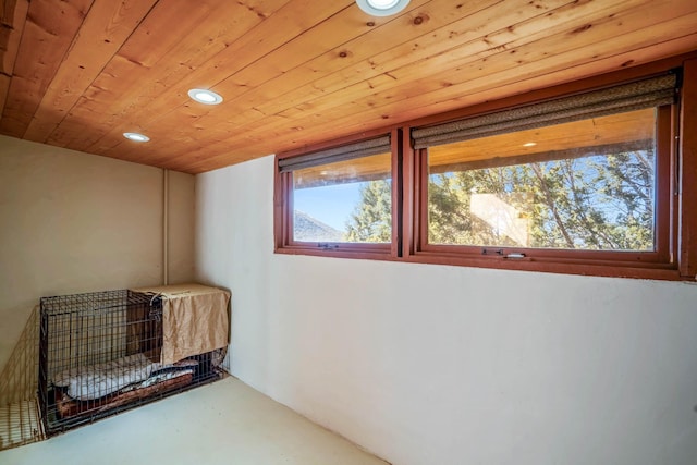 interior space featuring wooden ceiling and concrete flooring