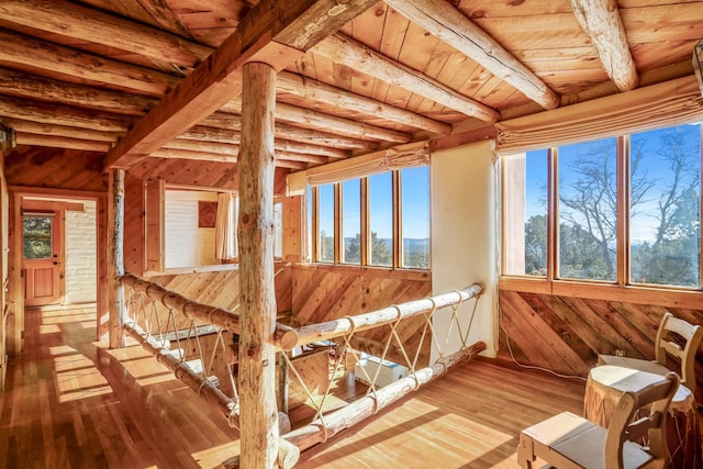 unfurnished sunroom featuring beam ceiling and wooden ceiling