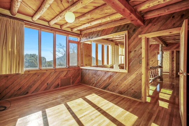 unfurnished sunroom with beam ceiling and wooden ceiling