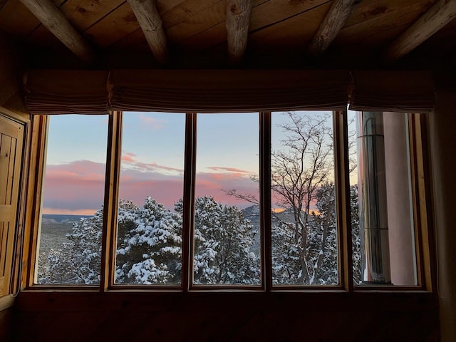 details with a mountain view, beamed ceiling, and wood ceiling