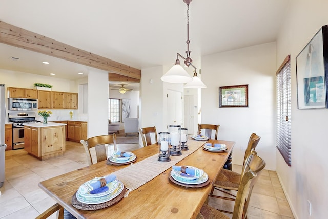 dining space with beamed ceiling, ceiling fan, and light tile patterned floors