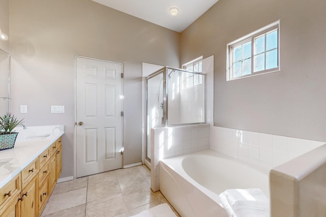 bathroom with tile patterned floors, vanity, and plus walk in shower