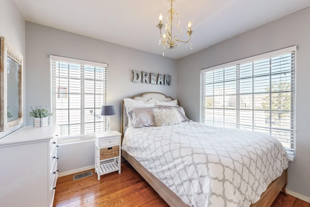 bedroom with a chandelier and hardwood / wood-style flooring