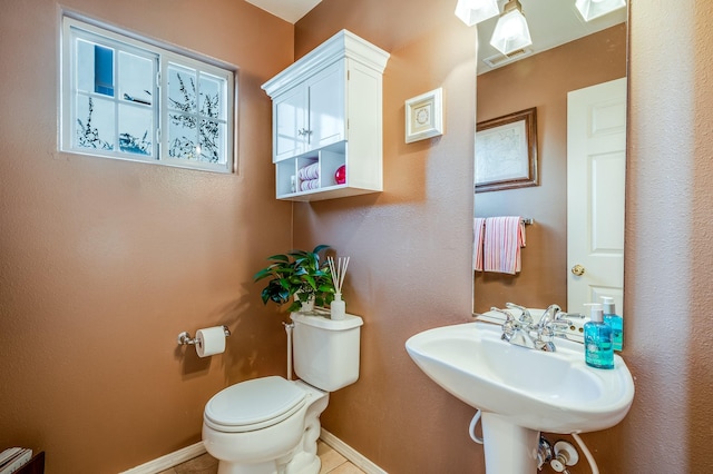 bathroom featuring sink, tile patterned flooring, and toilet