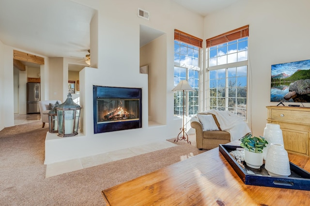 living room featuring carpet floors and ceiling fan