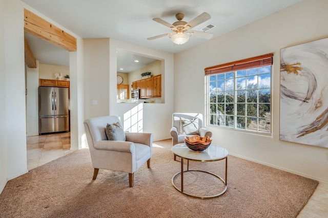 living area featuring ceiling fan and light tile patterned flooring