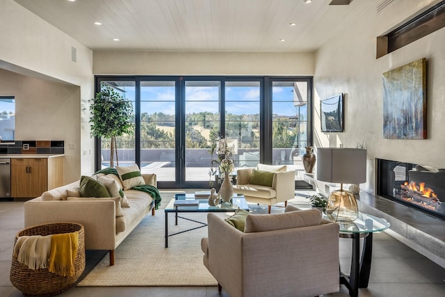 living room featuring wooden ceiling and a healthy amount of sunlight