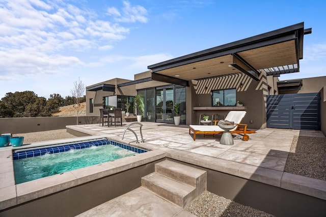 view of pool featuring a patio area and an in ground hot tub