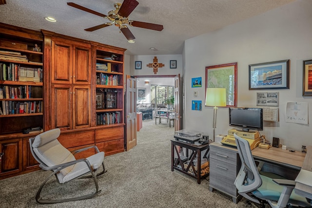 office area with light carpet, a textured ceiling, and ceiling fan