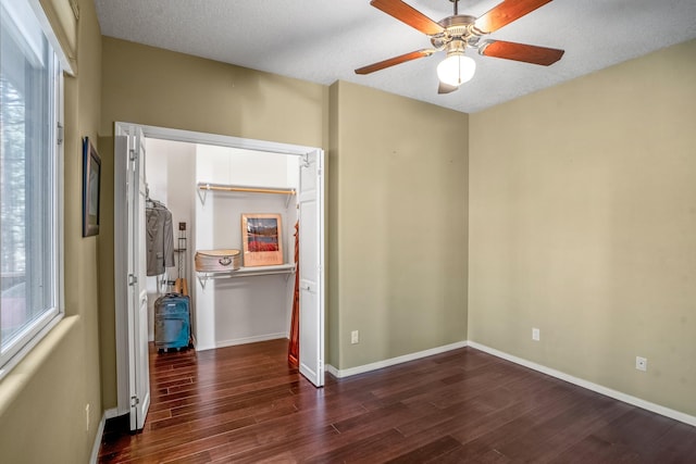 unfurnished room featuring a textured ceiling, dark hardwood / wood-style floors, and ceiling fan