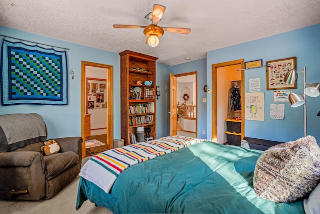 bedroom with connected bathroom, ceiling fan, a textured ceiling, a closet, and carpet