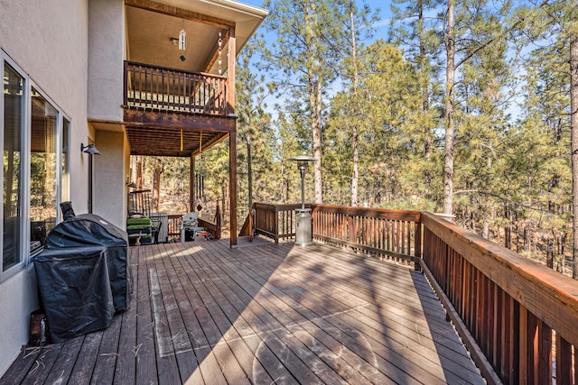 wooden deck with a grill