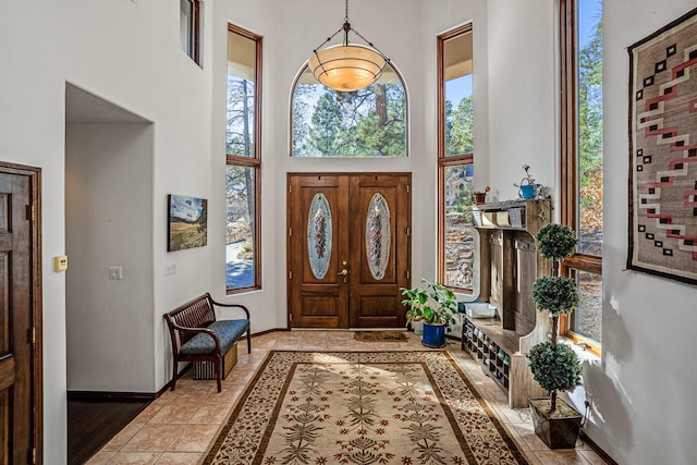 foyer entrance featuring light hardwood / wood-style floors and a towering ceiling