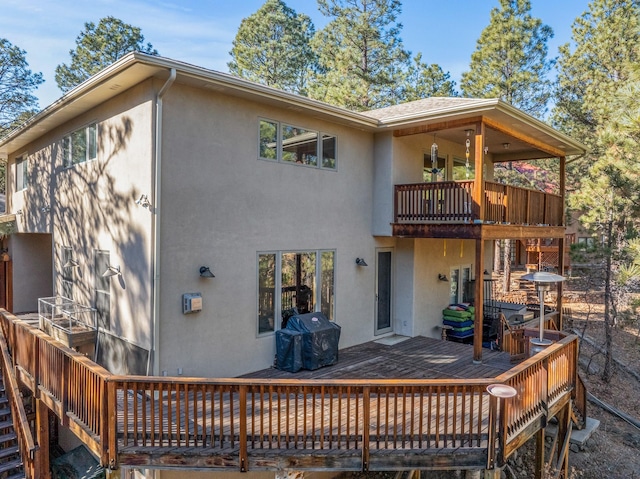 back of house with a balcony and a deck