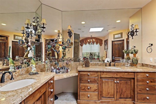 bathroom with a chandelier and vanity