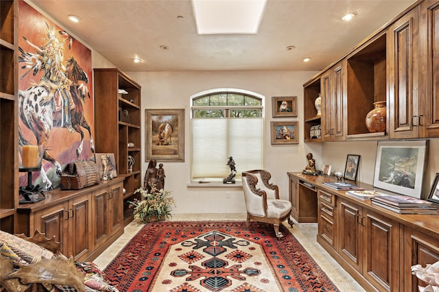 office area featuring light tile patterned floors and built in desk