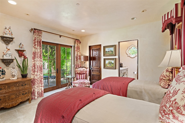 bedroom featuring ensuite bath, access to exterior, light colored carpet, and french doors