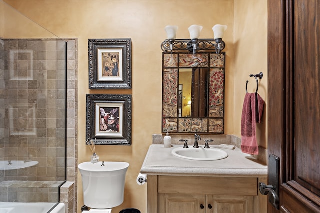 bathroom with vanity, toilet, and tiled shower