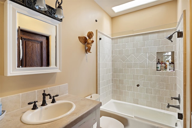 full bathroom with vanity, tiled shower / bath combo, and toilet