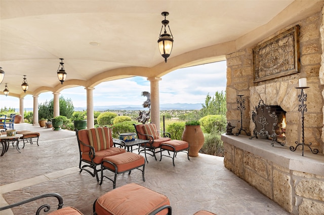 view of patio featuring an outdoor stone fireplace