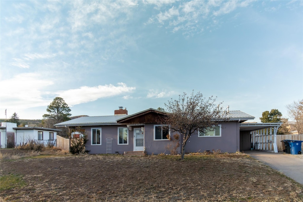 ranch-style home featuring a carport