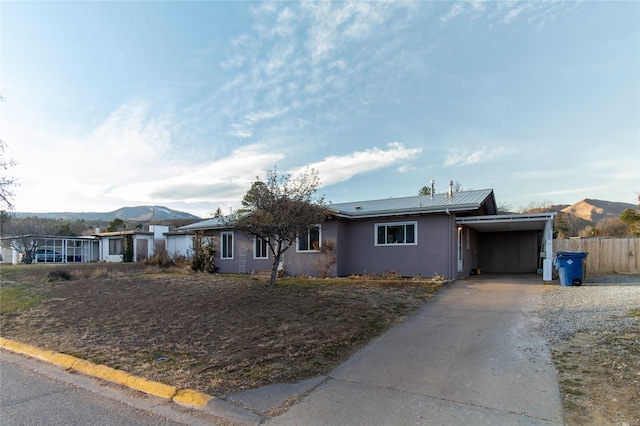 ranch-style house featuring a mountain view and a carport