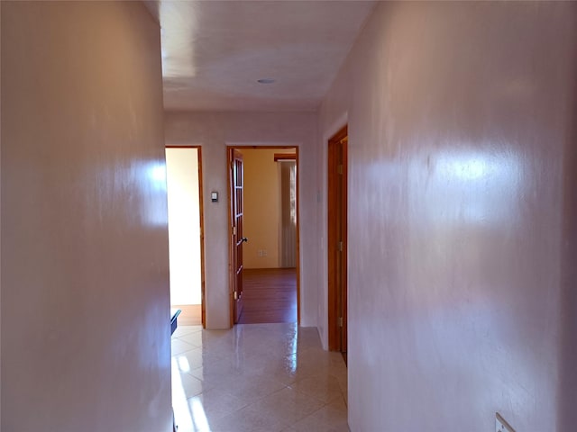 hall with light tile patterned floors