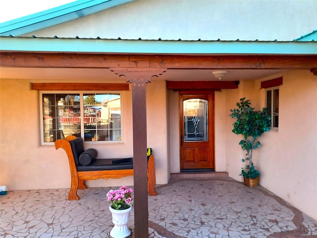 entrance to property featuring stucco siding