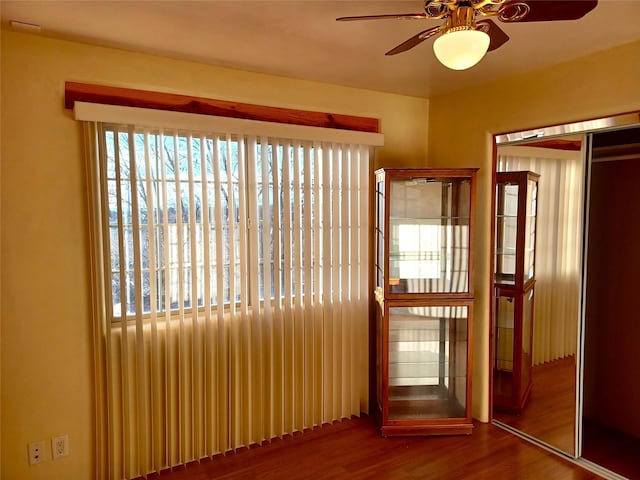 interior space with a ceiling fan and wood finished floors