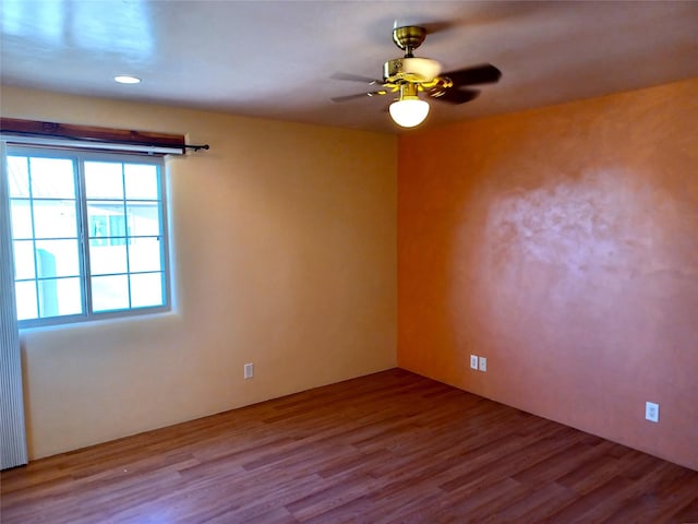 spare room featuring ceiling fan and wood finished floors