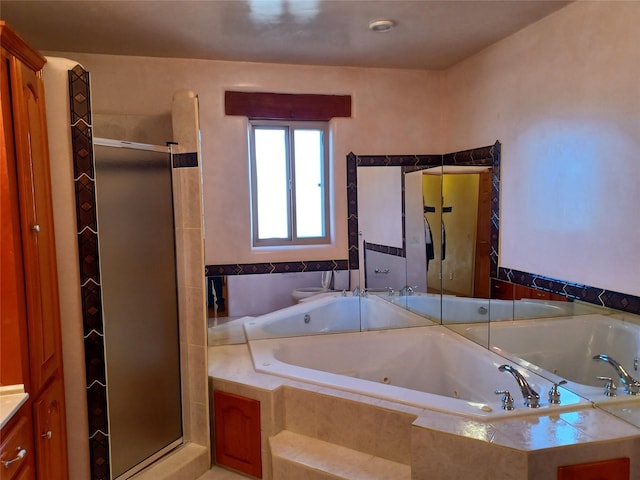 full bath with a stall shower, a tub with jets, and vanity