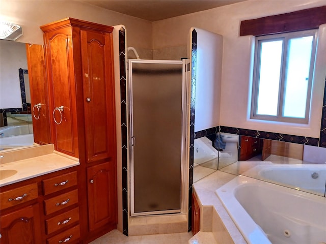 bathroom with toilet, a stall shower, a tub with jets, and vanity