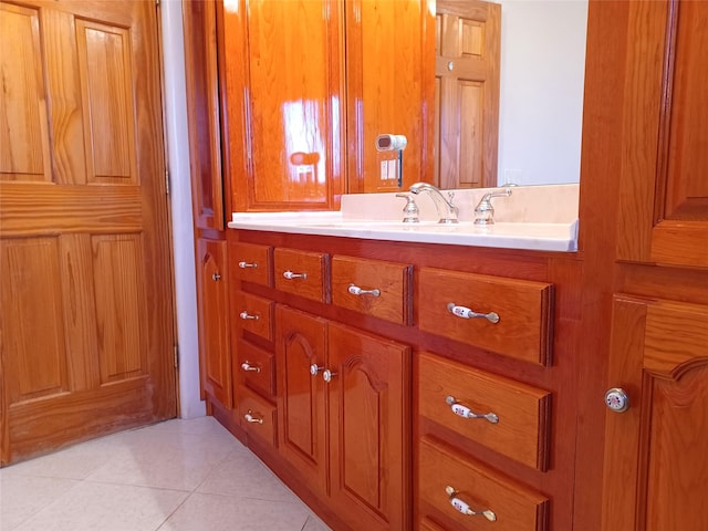 bathroom with tile patterned flooring and vanity