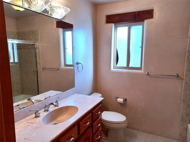 bathroom with a shower with shower door, vanity, and toilet