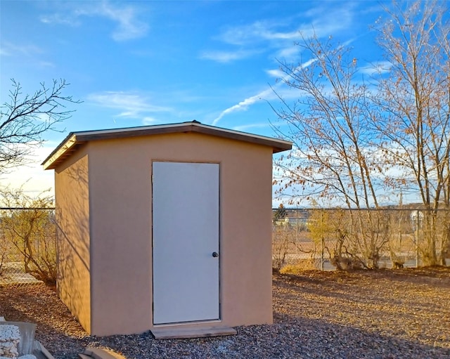 view of shed with fence