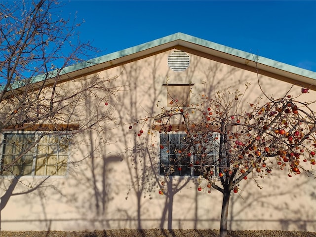 view of side of property featuring stucco siding