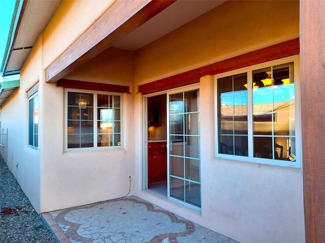 property entrance with stucco siding