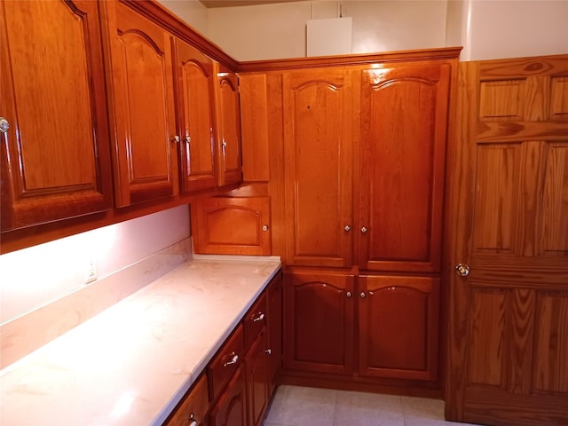 interior space featuring light countertops and brown cabinets