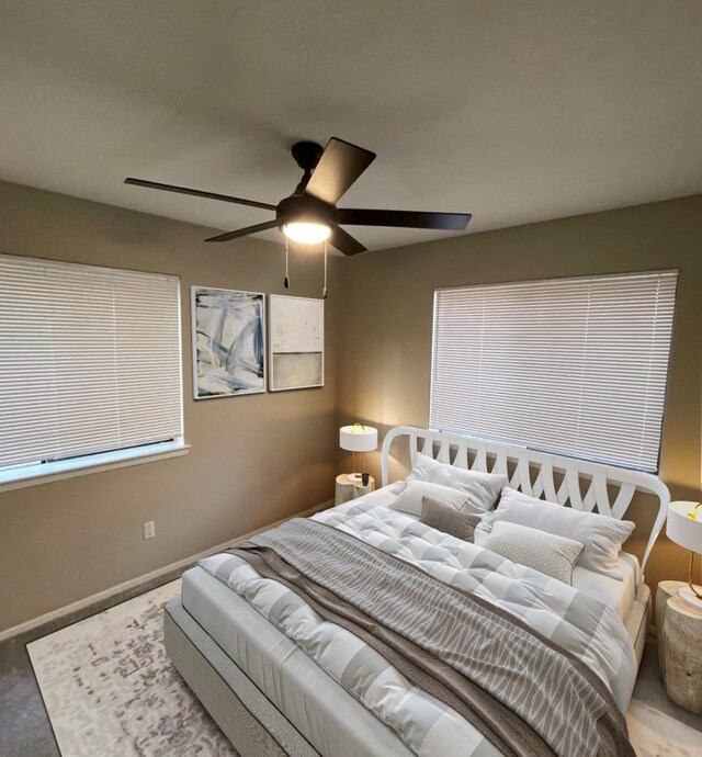 living room featuring tile patterned floors, ceiling fan, a textured ceiling, and a wealth of natural light